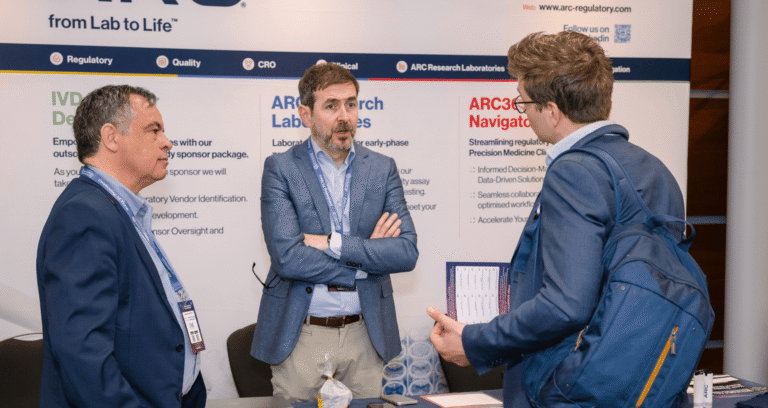 Conference delegates visiting sponsor booths at a peptide therapeutics industry exhibition.